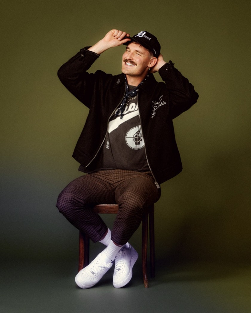 GRiZ seated on a chair tilting his head back